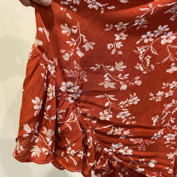 Burnt orange floral romper with ruffles and crisscross back (adjustable) - Picture 5 of 7